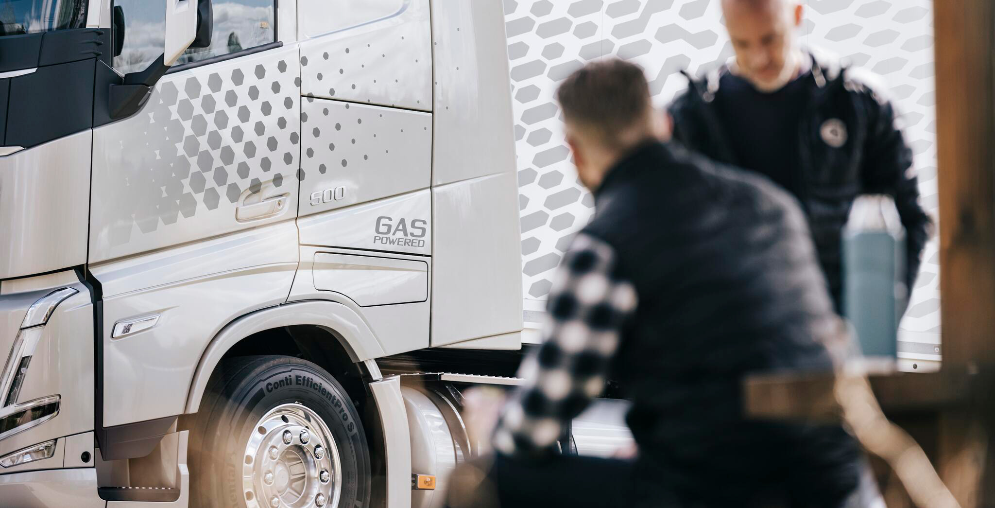 Man in front of gas-powered truck LNG